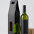 Caixa de cartão preta para garrafa de vinho com janela frontal e garrafa de vinho ao lado, embalagem premium para oferta e transporte de garrafas.