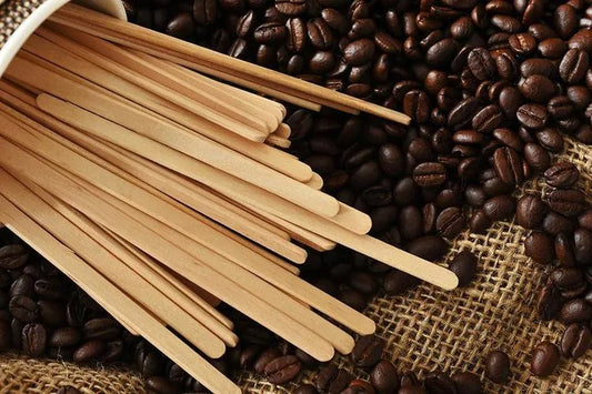 Agitadores de madeira de 9 cm sobre grãos de café e serapilheira
