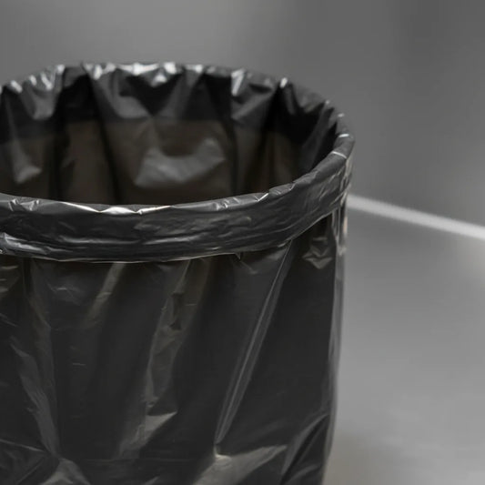 Saco de lixo preto AD a forrar um cesto, textura fosca — RAS Embalagens